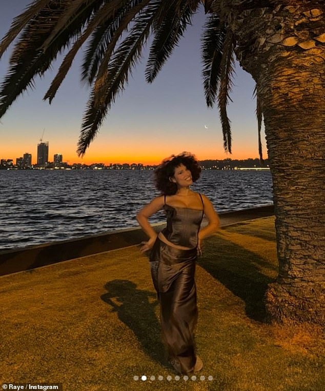 In her final photo, the singer was all smiles as she posed at the sunset in a brown satin corset and long skirt.