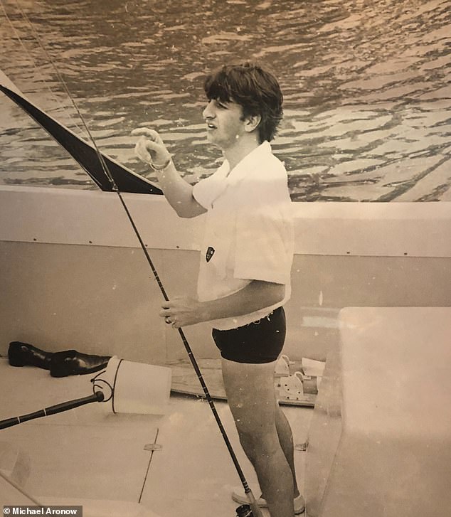 Iconic drummer Ringo is shown navigating the boat with ease, dressed in his swimsuit, dark spandex, and a white Cuban shirt. In another, he holds a fishing reel.
