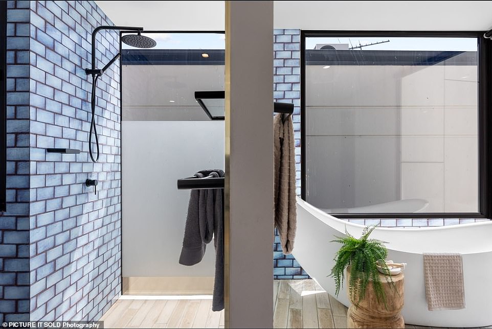 The second floor is completely occupied by the luxurious master bedroom with a wooden dressing room, as well as a blue-tiled bathroom with a sculptural hammock-shaped bathtub.