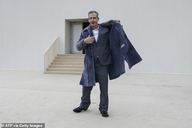 The Melbourne-born star cut a dapper figure in a smart gray suit and black dress shoes.