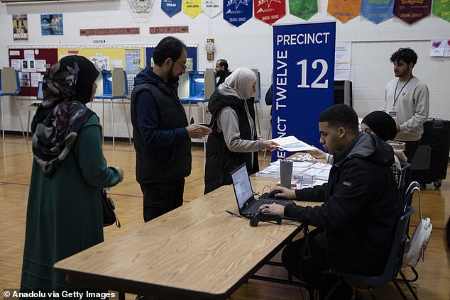 Voters in Dearborn, Michigan, are captured at a polling place. Both Michigan Democrats and Republicans held their primaries on Tuesday, and voters were able to choose which party primary they wanted to participate in.