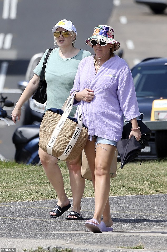 The 43-year-old completed her look with a white cap and reflective sunglasses and stayed on trend by carrying her valuables in a stylish fanny pack. She also carried a brown Woolies bag, which sells for 25 cents.