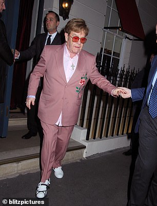 When he stepped out, he looked as dapper as ever in a pink suit and shirt and trendy tinted glasses.