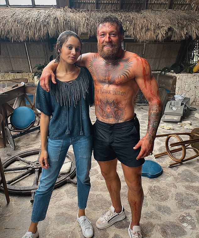 Conor looked bloodied as he posed shirtless in a behind-the-scenes photo from the set.