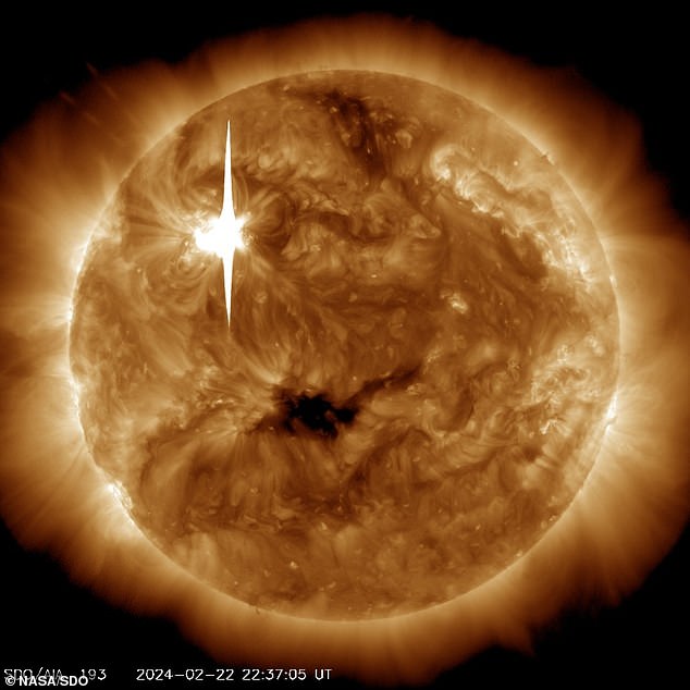 NASA's Solar Dynamics Observatory captured this image of the X6.3 solar flare (as seen in the bright flash at top left) on February 22, 2024. The image shows a subset of extreme ultraviolet light that highlights the material extremely hot in flares and which is colored in bronze
