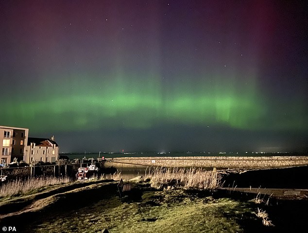 The Northern Lights seen over St Leonard's Head in St Andrews, Scotland, on February 27, 2023