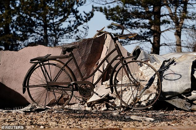 The remains of a bicycle are found in front of a home that was destroyed by the Smokehouse Creek wildfire. The Canadian Independent School District canceled classes on Wednesday