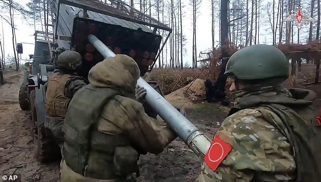 Russian soldiers load a rocket onto a Grad rocket launcher on a mission to an undisclosed location in Ukraine.