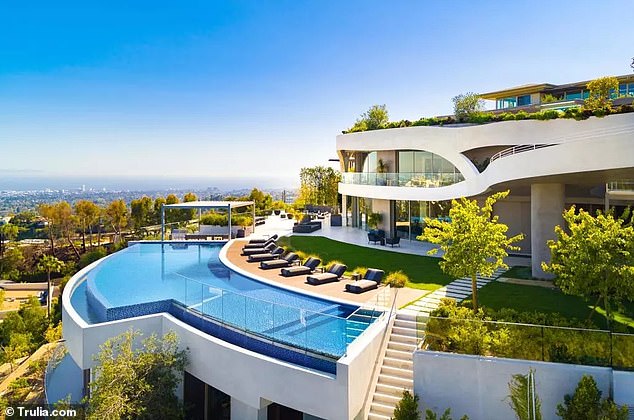 In the backyard is a long glass-bottom infinity pool that offers stunning views of Los Angeles.