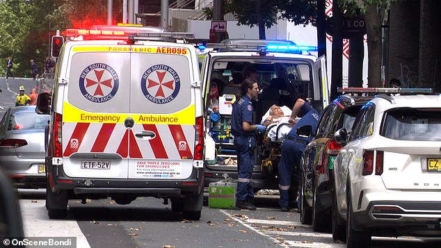 The injured man is seen being taken to an ambulance on Castlereagh Street.