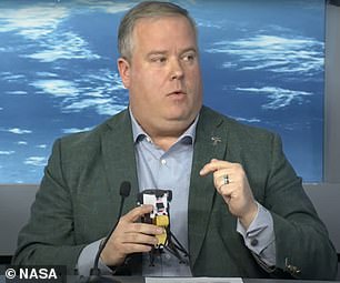 Above, Tim Crain, chief technology officer and co-founder of NASA contractor Intuitive Machines, illustrates details about the 'Odie' probe landing and resting against a rocky slope on the moon's surface.