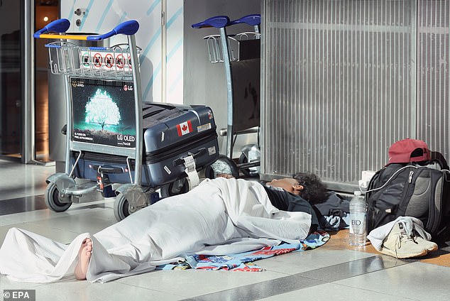 A passenger sleeps on the floor at the Ministerio Pistarini International Airport in Ezeiza, Argentina, on Wednesday after flights were canceled due to a 24-hour workers' strike. Three unions representing workers rejected a 12 percent pay increase offered last week