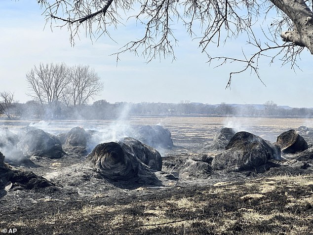 Smoke rises from burning hay bales outside the town of Canadian, Texas, on Wednesday.