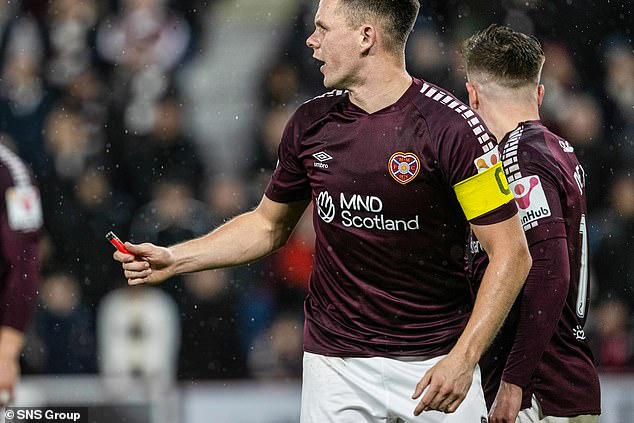 1709194576 902 Hearts striker Lawrence Shankland is pelted with objects including