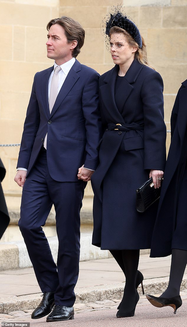 Princess Beatrice (pictured with her husband Edoardo arriving at the chapel), famous for her taste in hideous headdresses, was also in the photo despite not being a working royal.