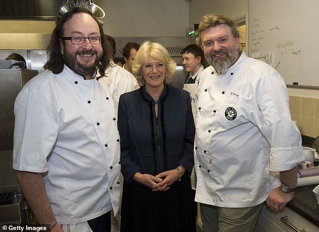 Camilla, Duchess of Cornwall (C) and furry cyclists Dave Myers (L) and Si King (R) attend the British Food Fortnight Secondary Schools Competition at Clarence House, January 27, 2011.