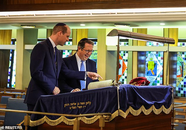 Rabbi Daniel Epstein shows Britain's Prince William a 17th-century Torah scroll while visiting the Marble Arch Western Synagogue.
