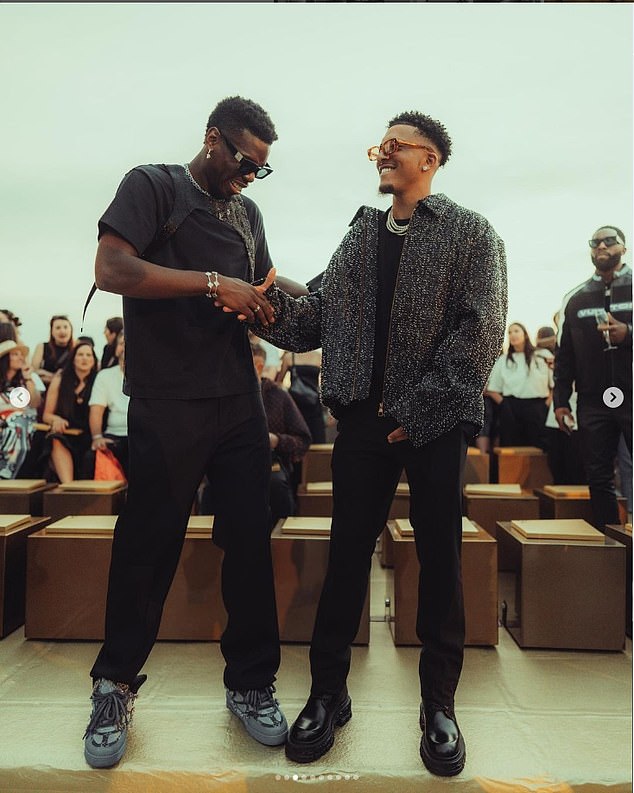The former Man United star shared a photo at Paris Fashion Week with Jadon Sancho (right)