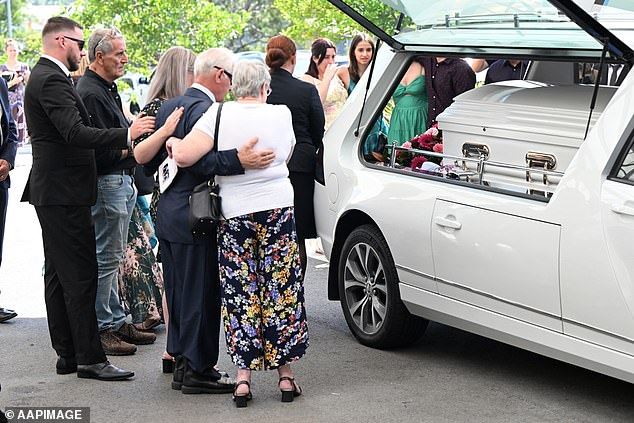 There were emotional scenes outside the church after Mrs White's funeral as friends and family comforted each other (pictured).