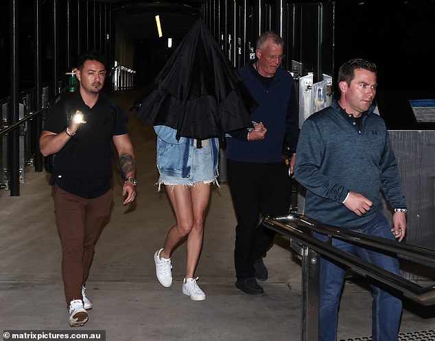His departure comes just hours after his father Scott (centre right), 71, was accused of punching photographer Ben McDonald, 51, in Australia at around 2.30am on Tuesday.