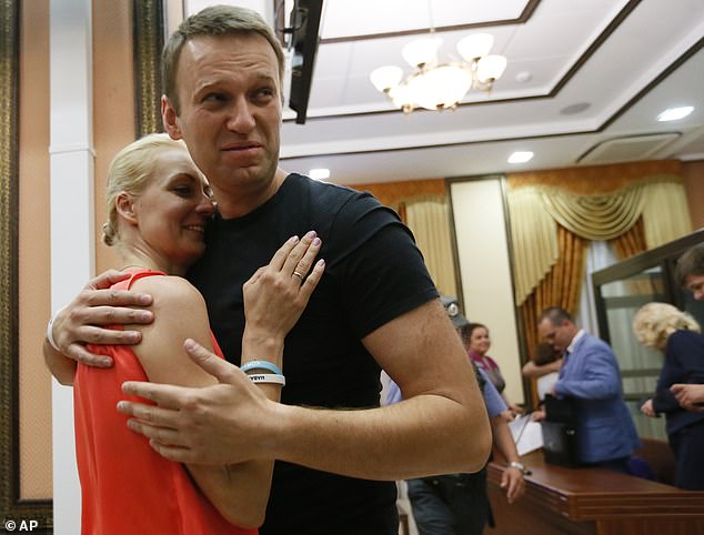 Russian opposition leader Alexei Navalny, right, hugs his wife Yulia, as he was released by a court in Kirov, Russia, on July 19, 2013.