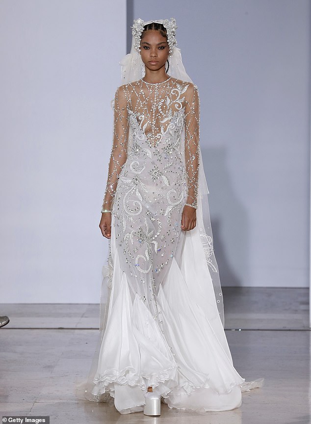 The sheer bridal trend took over the runway, with this model arriving at Paris Fashion Week in a low-cut and revealing dress.