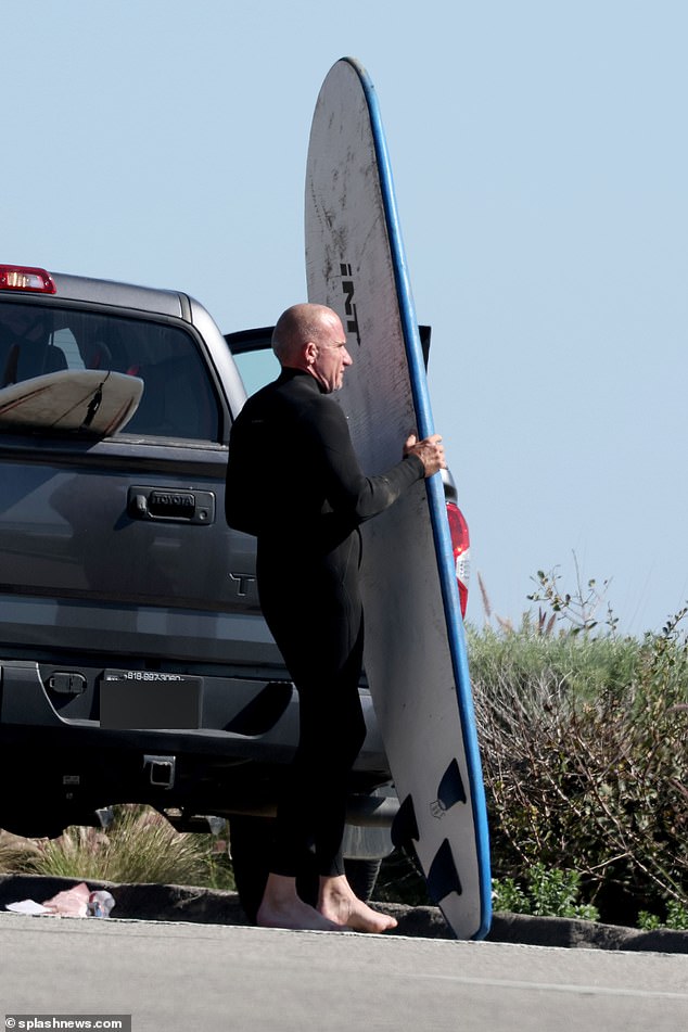 He had several surfboards in his truck and was seen taking one out to prepare it for the waves.