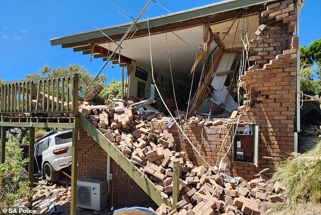 A driver who forgot to put the handbrake on his car caused the destruction of a house after the vehicle plowed through the property (pictured)