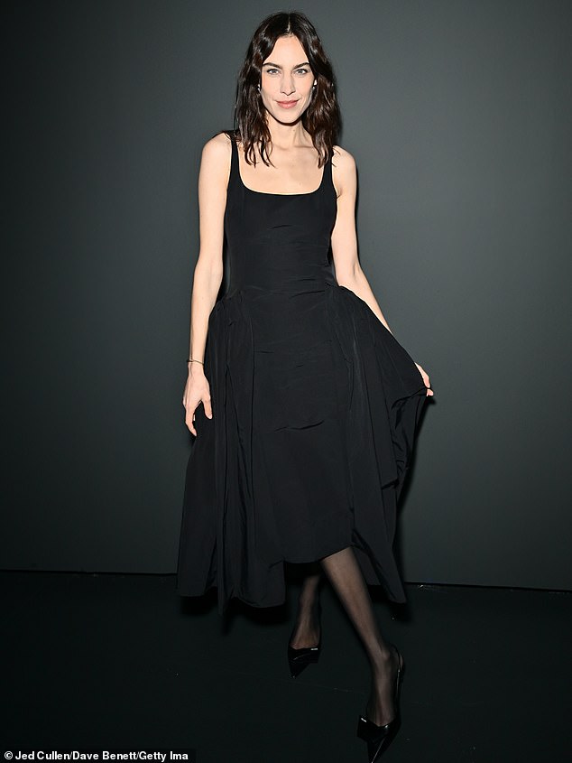 Alexa Chung cut an elegant figure in a plain black dress at the 16Arlington show on the second day of London Fashion Week on Saturday.