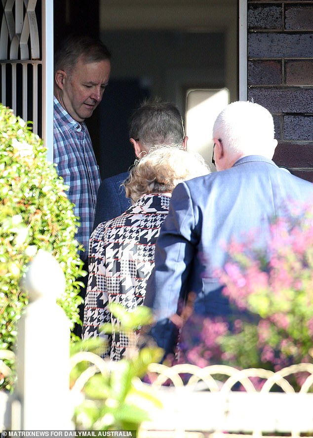 Mr Albanese is seen opening the front door of his home in Marrickville, in Sydney's inner west, as senior bureaucrats walked inside.