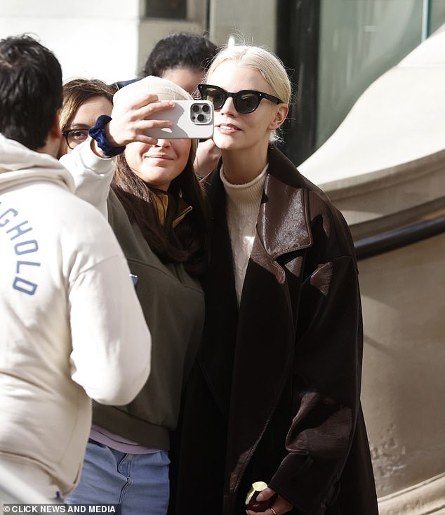Anya-Taylor Joy, 27, took selfies with fans outside her London hotel after being accused of Muslim cultural appropriation for wearing a hooded veil at the premiere of Dune: Part Two.