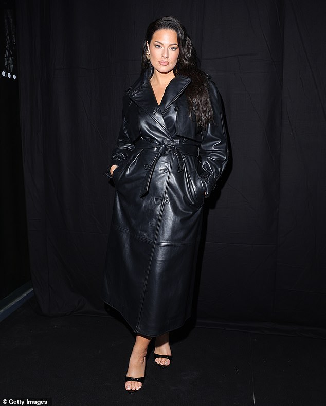 Ashley Graham looked chic in a black leather trench coat while watching the Alberta Ferretti show during Milan Fashion Week on Wednesday.