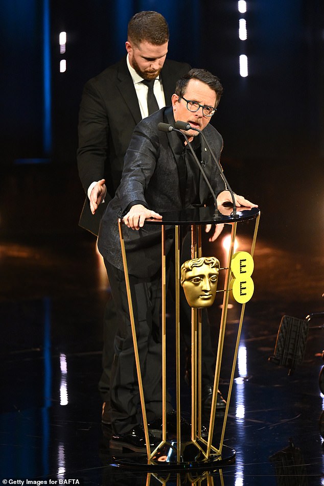 Michael J. Fox received a standing ovation from the stars attending the 2024 British Academy Film Awards on Sunday as he took the stage in a wheelchair.