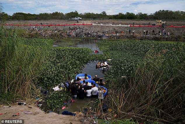 People cross the Rio Grande to surrender in Brownsville, Texas, to the authorities to begin their immigration process