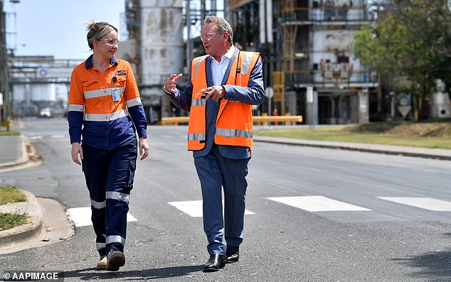 Andrew Forrest (right) talks to a worker at a Queensland plant his company Fortescue Metals is partnering with to develop hydrogen as an example of green energy.