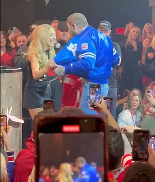 The NFL WAG went on stage at the XS Nightclub to take the singer's jacket