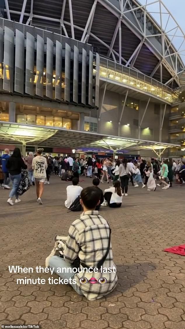 The clip, which was filmed on Saturday night during Swift's second show in Sydney, shows hordes of ticketless Swifties rushing towards the ticket booths after organizers announced the news over the loudspeakers.