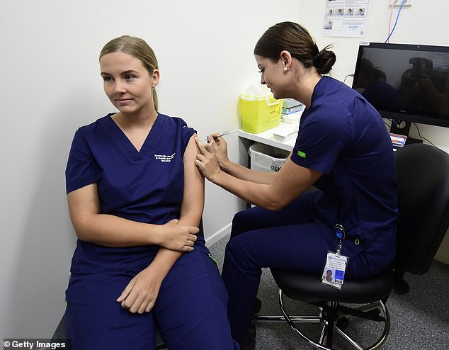 A court found that Queensland police and ambulance workers were unlawfully instructed to receive Covid-19 vaccines (pictured, a nurse is vaccinated in Townsville, Queensland)