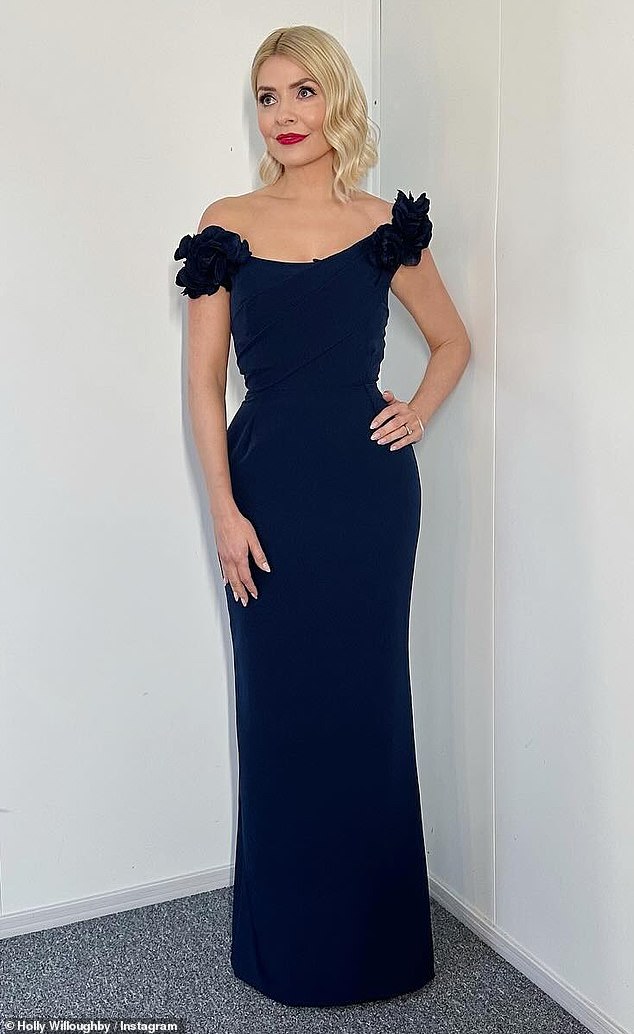Holly Willoughby was the epitome of glamor as she posed in an off-the-shoulder stretch crepe dress with 3D flower details by Marchesa ahead of Dancing On Ice on Sunday.