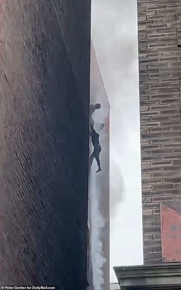 Desperate New Yorkers hang out of windows to escape fire