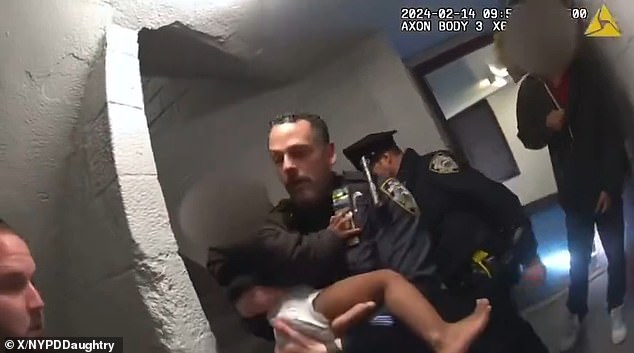 Dramatic footage captures hero cops rescuing babies in diapers and a man on crutches as they race to evacuate a burning apartment building in Brooklyn, New York.