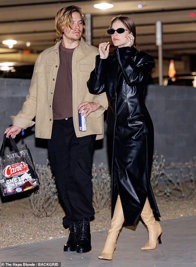 Dylan Sprouse and model wife Barbara Palvin make a fashionable appearance at Super Bowl LVIII in Las Vegas as he carries a can of beer
