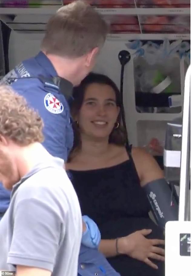 Gretta (pictured receiving treatment after the incident) and Sebastian Lough were driving along Eastern Distributor near the Randwick/Bondi exit at lunchtime on Thursday when smoke began coming out of the engine of their Hyundai.