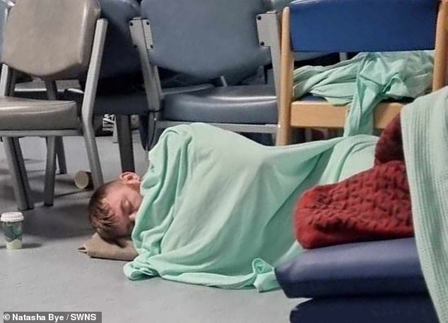Steven Wells (pictured sleeping on the floor at William Harvey Hospital in Ashford, Kent) endured a 45-hour A&E wait after he began vomiting blood and was forced to sleep on the floor in November while waiting to be admitted.