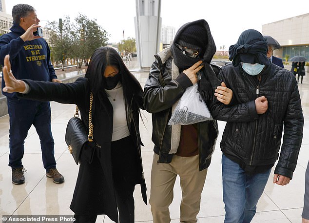 Alexander Smirnov, second from right, leaves the courthouse on February 20, 2024 in Las Vegas.
