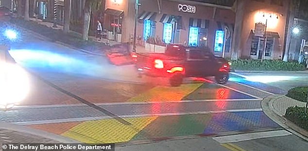 Surveillance footage shows the moment the wheel of a large 4x4 is seen spinning across the stretch of road, before driving away, leaving black marks across the intersection.