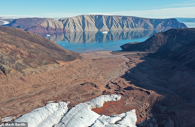 An estimated 11,000 square kilometers of Greenland's ice sheet and glaciers have melted over the past three decades, according to a major analysis of historical satellite records.  Pictured is exposed land from above Sydgletscher looking into Bowdoin Fjord, in Qaanaaq, northwest Greenland.