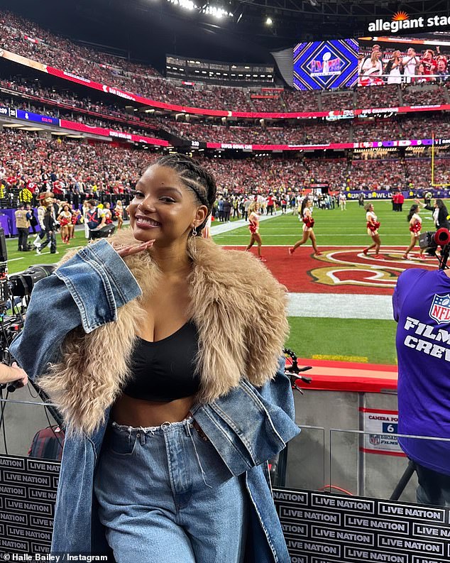 Halle Bailey showed off her toned midriff in a plunging black crop top at the 2024 Super Bowl, just a month after giving birth to her first child, a boy, named Halo.