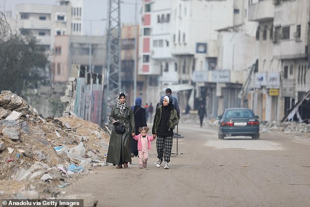 Palestinians return to their neighborhood after Israeli forces withdrew from the neighborhood district of Shuja'iyya and inspect buildings and roads destroyed due to Israeli attacks on Gaza City on Tuesday.