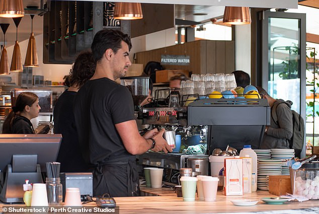 You can leave something when you pick up your flat white without causing offense in Australia.  However, no one will be mad if you don't do it.  In the photo, a barista preparing coffee in Perth.